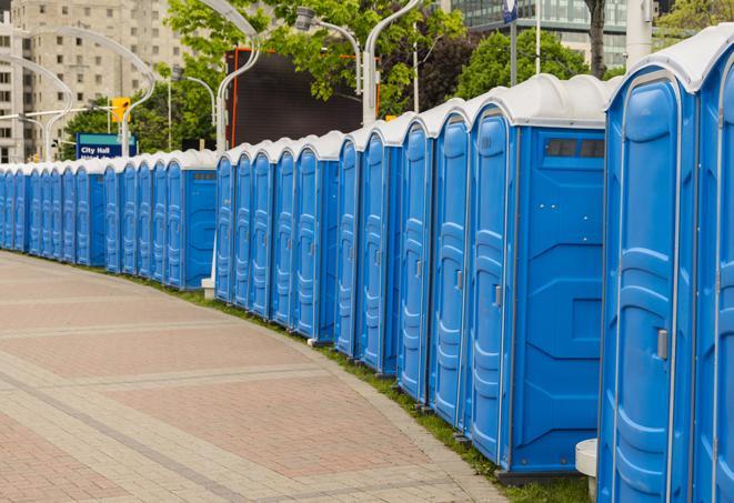 a row of portable restrooms set up for a large athletic event, allowing participants and spectators to easily take care of their needs in Garwood NJ